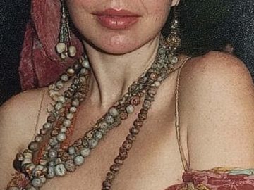 Woman wearing headscarf and layered beaded necklaces