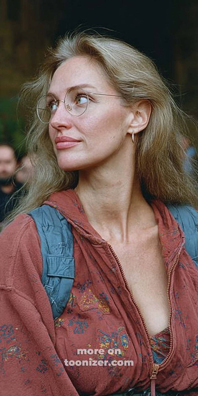 Blonde woman with glasses looking sideways outdoors